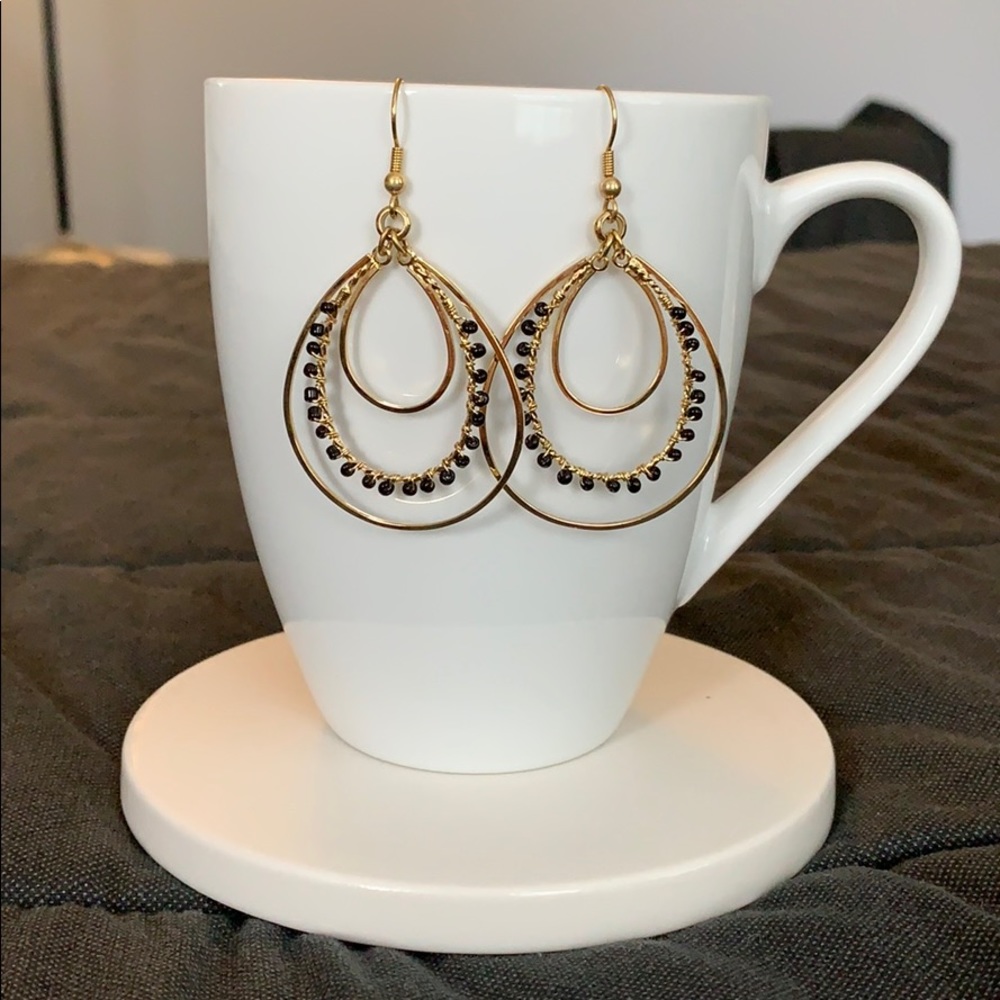 Gold tone earrings with black beads